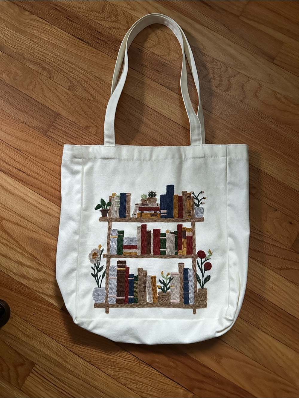 Cream Canvas Tote Bag with Embroidered Bookshelf Design